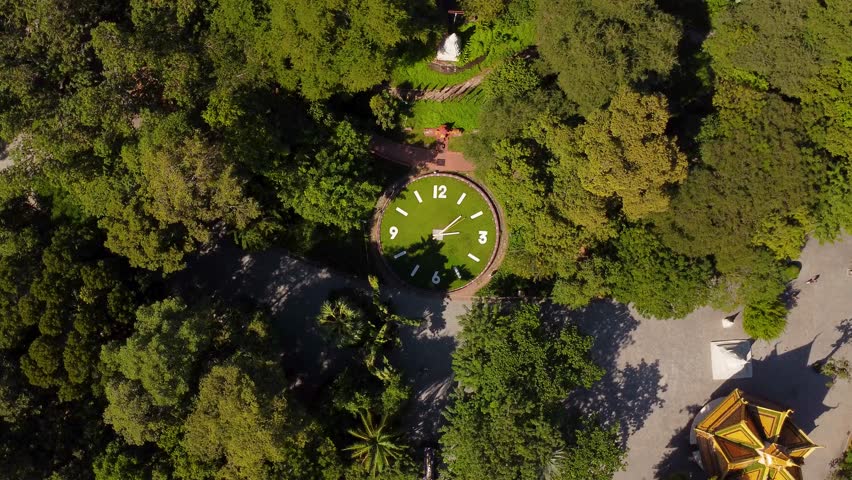 Drone circles around Historical monument The Giant Clock of Phnom Penh city Buddhist temple park, Wat Phnom
