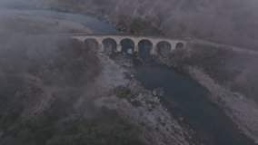 Aerial view of railway bridge over varbitsa river at sunrise with fog in a tranquil valley, Balabanovo, Bulgaria. - Powered by Shutterstock - Get 15% off with code: PIKWIZARD15
