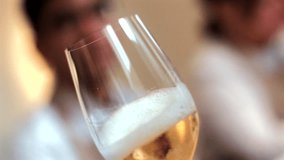 A close-up of a flute glass filled with sparkling white wine or champagne, gently swirled to showcase the bubbling effervescence and creamy foam - Powered by Shutterstock - Get 15% off with code: PIKWIZARD15