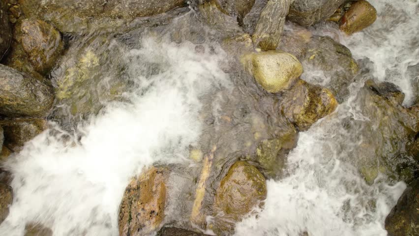 Close-up of rushing water flowing over smooth rocks in the Ammonoosuc River.