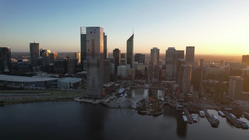 Aerial view of beautiful skyline over Swan River with Elizabeth Quay Bridge and The Bell Tower at sunset, Perth, Australia.