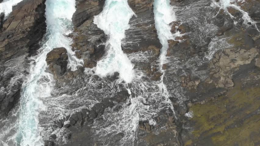Aerial view of waves breaking over rocks in blue ocean, Ocean waves in beutiful.