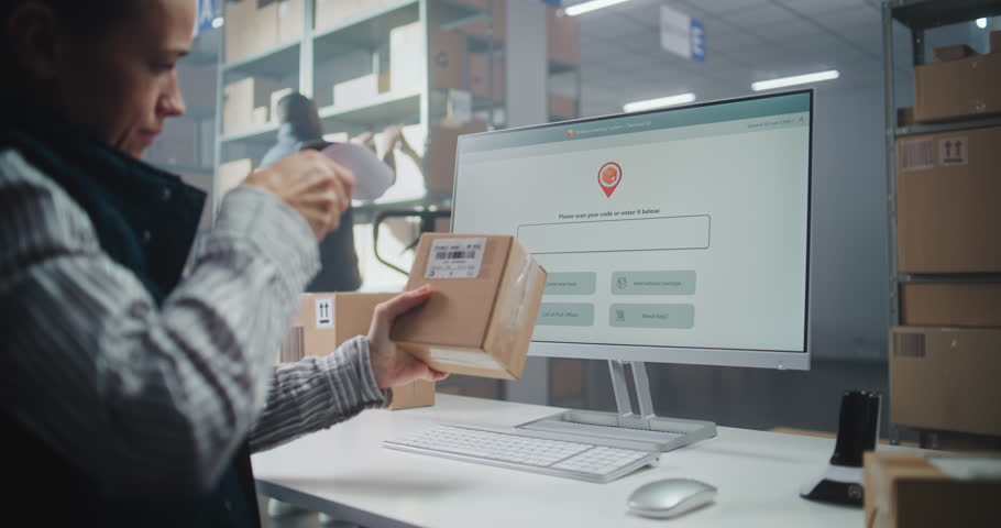 Female Inventory Manager Scans Code on Cardboard Box with Barcode Scanner, Checks Parcel Information. Computer Screen Shows Delivery Tracking System for Monitoring Package with Online Orders. Close Up