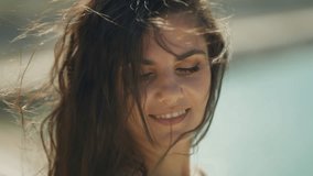 Close-up of smiling woman with wind-blown hair. Happy woman concept. - Powered by Shutterstock - Get 15% off with code: PIKWIZARD15