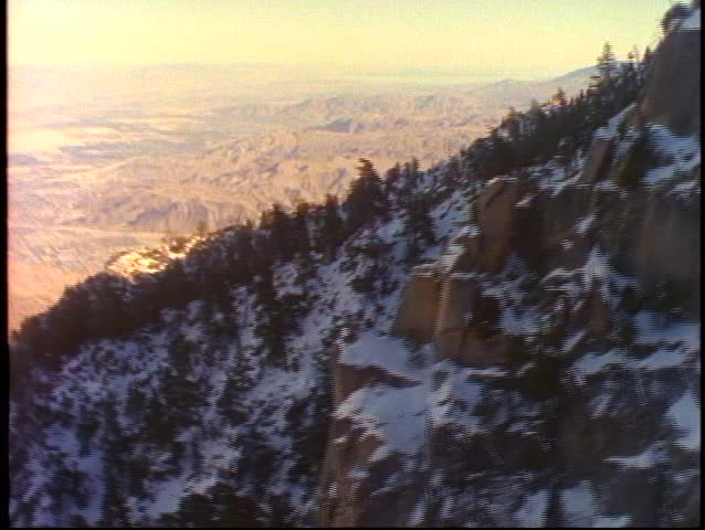 The Palm Springs Tram climbs up the snow covered mountains near Palm Springs