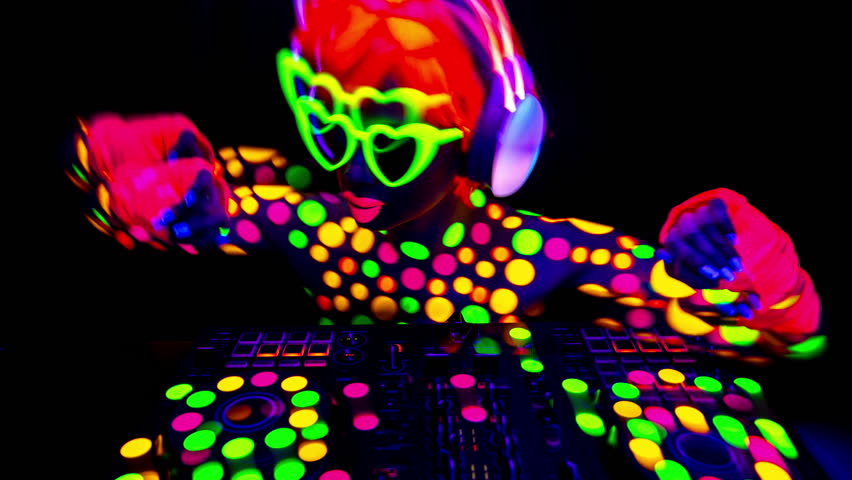 A cool DJ woman wearing UV fluorescent clothing and makeup 