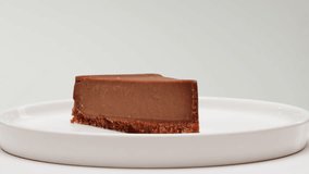 Chocolate dessert cheesecake on plate close-up. Cheesecake is a dessert made with a soft fresh cheese , typically cottage cheese, cream cheese, quark or ricotta, eggs, and sugar. It may have a crust - Powered by Shutterstock - Get 15% off with code: PIKWIZARD15