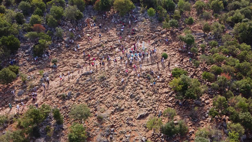 Aerial view of Mount Podbrdo and people on pilgrimage to the statue of Our Lady where the apparitions took place in Medjugorje.