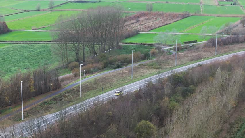police car driving road complete illuminated lights sirens speed associated emergency response dynamic aerial drone shot view community