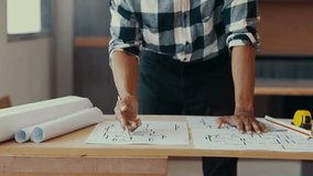 Architect making adjustments to a blueprint with a pencil at a desk, focusing on design details for a construction project - Powered by Shutterstock - Get 15% off with code: PIKWIZARD15