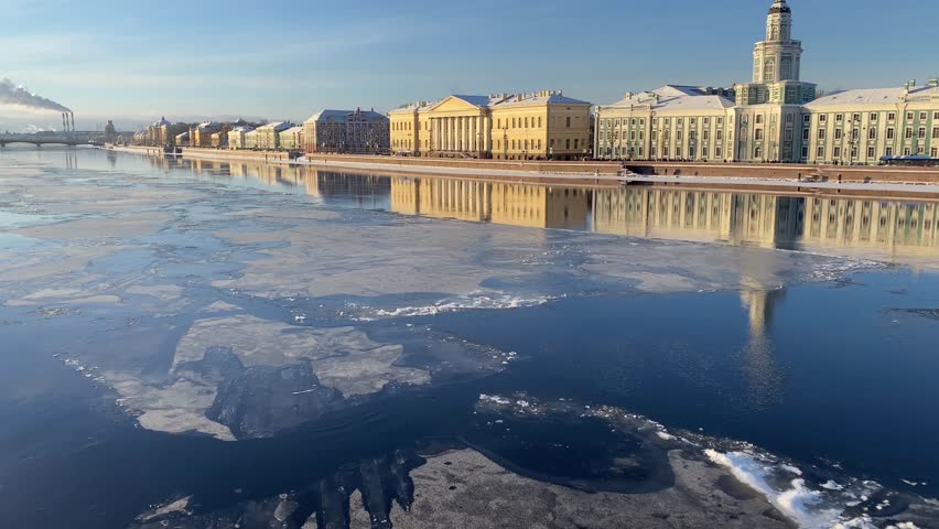 Ice floats on the Neva river in Saint-Petersburg. Russia. View of embankment and city river with ice drifting on winter day.