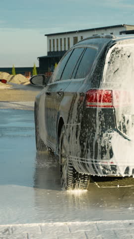 Man Applying Foam on Car at Outdoor Self-Service Car Wash