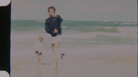 Vintage shot of a father adjusting his young son's fishing rod, with ocean waves crashing in the background, capturing a heartfelt moment of bonding by the shore - Powered by Shutterstock - Get 15% off with code: PIKWIZARD15
