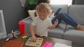 Woman relaxing on sofa with tablet while young boy plays with puzzle in cozy living room. - Powered by Shutterstock - Get 15% off with code: PIKWIZARD15