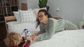 Mother and son playing happily with a robot on a cozy bed in a modern bedroom, embodying family love and connection. - Powered by Shutterstock - Get 15% off with code: PIKWIZARD15