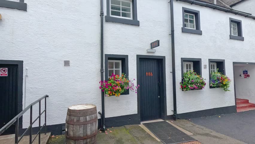 White building with flowers and cloudy sky