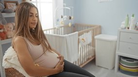 Pregnant woman sitting in cozy nursery room, surrounded by baby crib and toys, reflecting on motherhood journey. - Powered by Shutterstock - Get 15% off with code: PIKWIZARD15