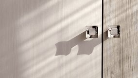 Furniture silver handles on structural laminated chipboard facades doors in striped shadows from sunlight close-up. Furniture fittings. - Powered by Shutterstock - Get 15% off with code: PIKWIZARD15