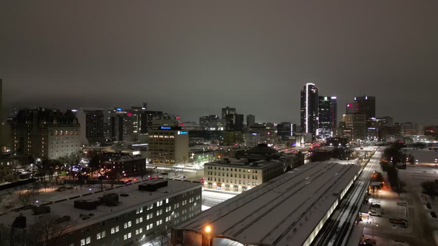 Downtown Winnipeg skyline on snowy winter night drone aerial