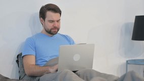 Middle Aged Man with Back Pain Working on Laptop in Bed - Powered by Shutterstock - Get 15% off with code: PIKWIZARD15