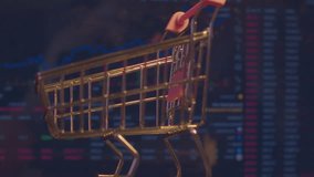 Modern economics. Business concept of securities trading. A small shopping cart from a supermarket stands against the background of a computer monitor on which economic data is changing. Close-up. - Powered by Shutterstock - Get 15% off with code: PIKWIZARD15