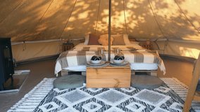 Interior of a glamping tent with chairs outside, nature, green grass and trees, trail - Powered by Shutterstock - Get 15% off with code: PIKWIZARD15