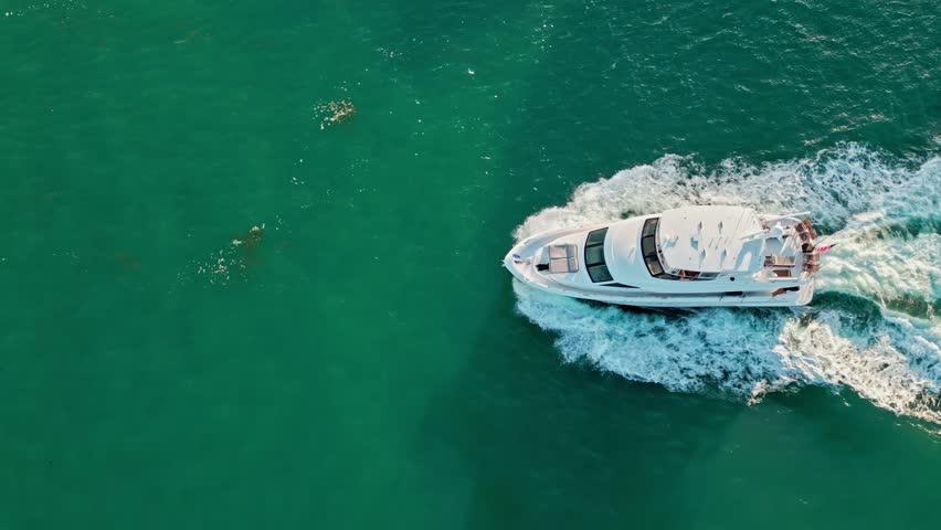 Luxury lifestyle. Vacation on summer. Yacht at sea. Motorboat yacht sailing at sea. Motorboat aerial top view. Luxury boat motor yacht at sea. Yachting boat tourism. Motorboat gliding through the sea