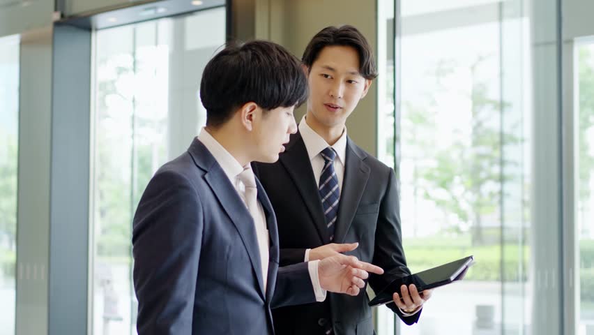Businessman giving instructions while walking