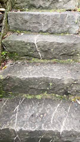Climbing stone steps on mountain. Ancient construction. Traditional buildings in Italy, Liguria. Municipality of Monella near Mediterranean Sea. 
