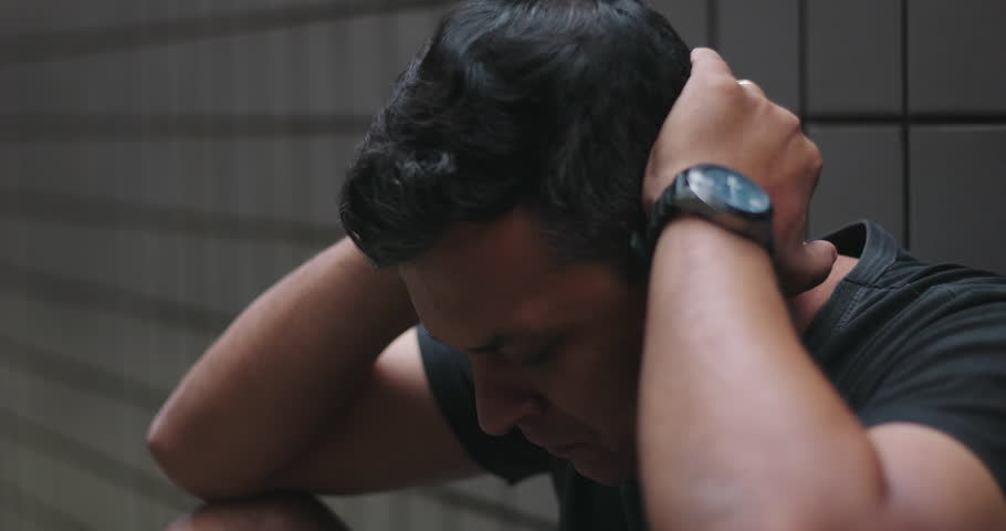 Close-up of man clasping hands near face, emotional vulnerability, inner turmoil, seeking strength amidst personal struggles, mental health awareness, and resilience