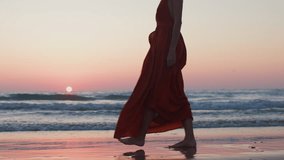 slender girl in a beautiful evening dress walks along the beach. lonely girl in a red evening dress on the beach. - Powered by Shutterstock - Get 15% off with code: PIKWIZARD15
