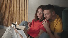 On a cozy evening, a couple shares a beloved book by candlelight, creating a warm, intimate moment that showcases their deep connection and relaxation in their peaceful home - Powered by Shutterstock - Get 15% off with code: PIKWIZARD15