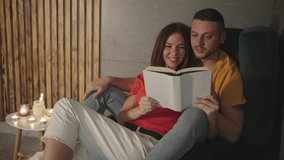 In a cozy room with flickering candles, a man and woman sit on a sofa, engrossed in their books, reflecting their deep love, emotional connection, and shared moments of contentment - Powered by Shutterstock - Get 15% off with code: PIKWIZARD15