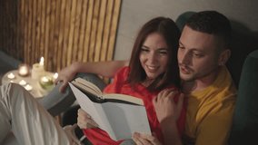 Cozy Moments A Couple Enjoying a Book Together in a warm and inviting atmosphere, creating an experience filled with affection, and togetherness, wrapped in comfort and love - Powered by Shutterstock - Get 15% off with code: PIKWIZARD15