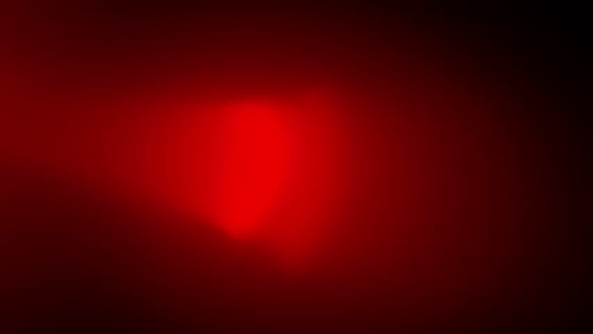 Real red optical lens flare on black background