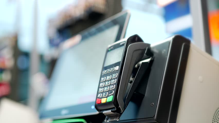 Close up man At Counter Buy electronic payment supermarket by credit card close-up. Male hand pay for purchases in stores Contactless NFC pos Terminal Closeup card reader at cashless wallet