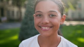 American Latina little girl outdoors portrait happy smiling child school student pupil teen in city looking at camera college academy primary education beautiful face kid schoolgirl daughter studying - Powered by Shutterstock - Get 15% off with code: PIKWIZARD15