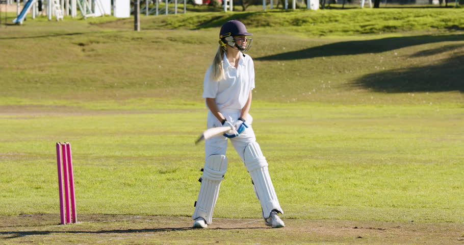 Playing cricket, female athletes walking on field during sunny day match. Sports, women, teamwork, competition, game, fitness