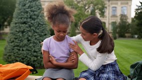 African Latina pupils primary school education little girls teen students schoolgirls studying children kids sad upset offended worried conflict sorry friend calm help support friendship city outdoors - Powered by Shutterstock - Get 15% off with code: PIKWIZARD15