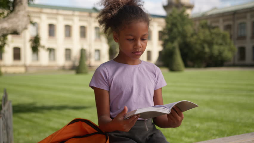 African American little girl daughter pupil student schoolgirl preparing exam studying copybook homework thinking education child kid book knowledge learning lesson task think city outdoor school yard