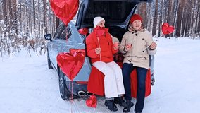 Couple celebrates Valentine's Day in winter wonderland with heart-shaped decorations - Powered by Shutterstock - Get 15% off with code: PIKWIZARD15