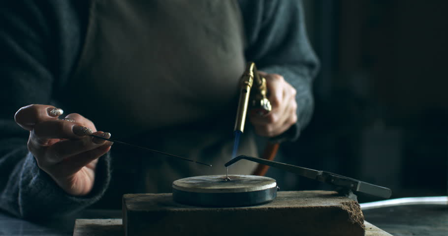 Super slow motion of Jewelry Making: Artisan Using Torch and Tools to Melt Metal on Workbench - Crafting Process in Workshop at 1000 fps.