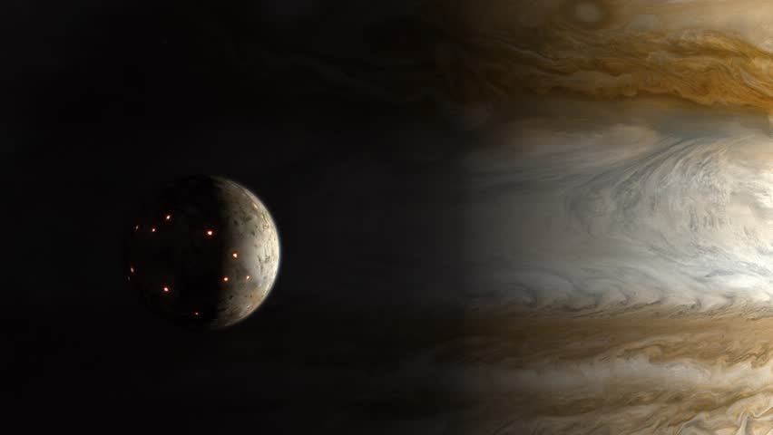 Long Establishing Shot of the Volcanic Moon Io Emerging From the Shadow of the Gas Giant Jupiter