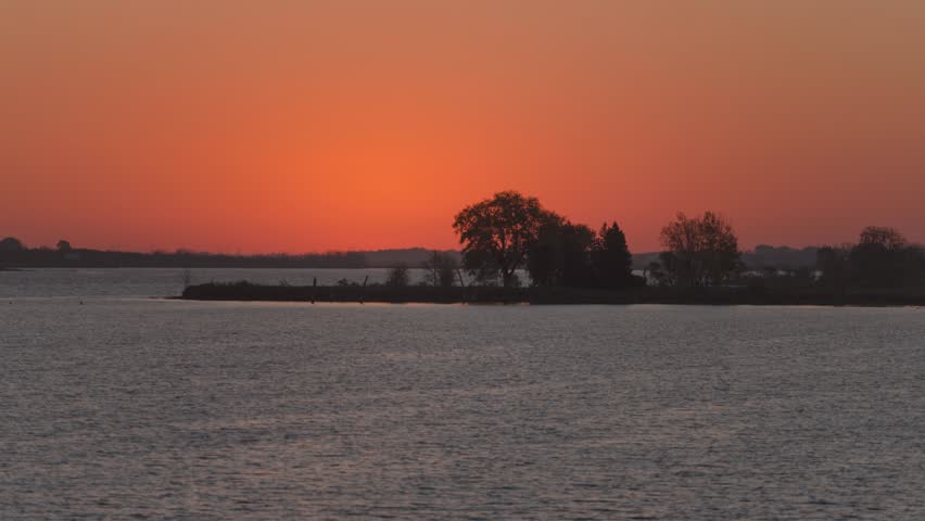 Timelapse view of sunrise over a Prairie lake in South Dakota, USA during dawn.