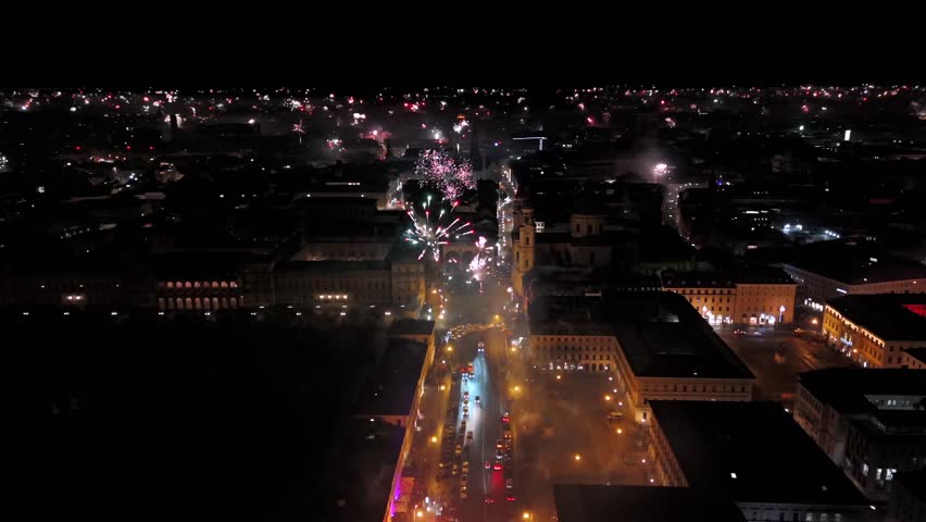 Silvester Muenchen, Deutschland, Odeonsplatz Luftaufnahme. Aerial view of Munich, Germany, showcasing vibrant New Years Eve fireworks display over city center. Stadt versinkt im Funkenregen. Salute. 