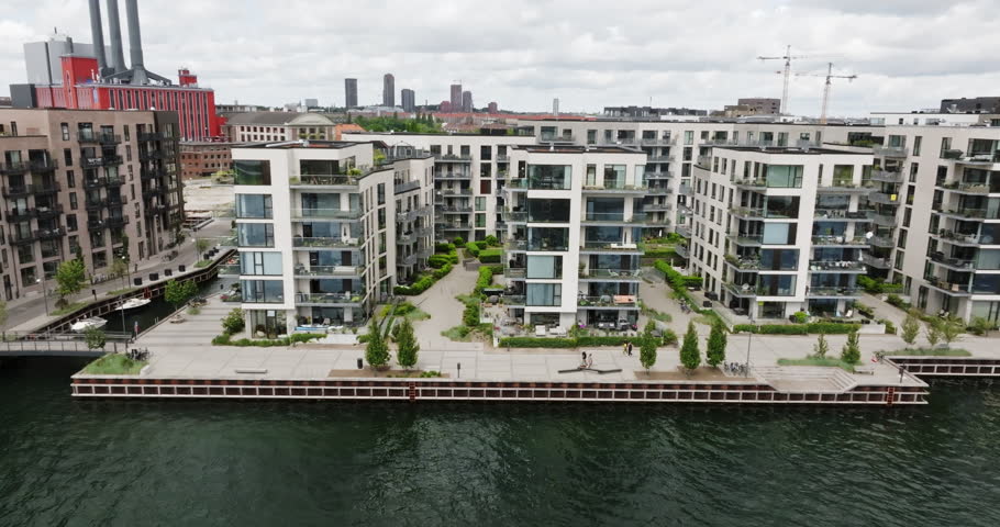 Drone flying in front of condos at Sydhavn river, summer in Copenhagen, Denmark
