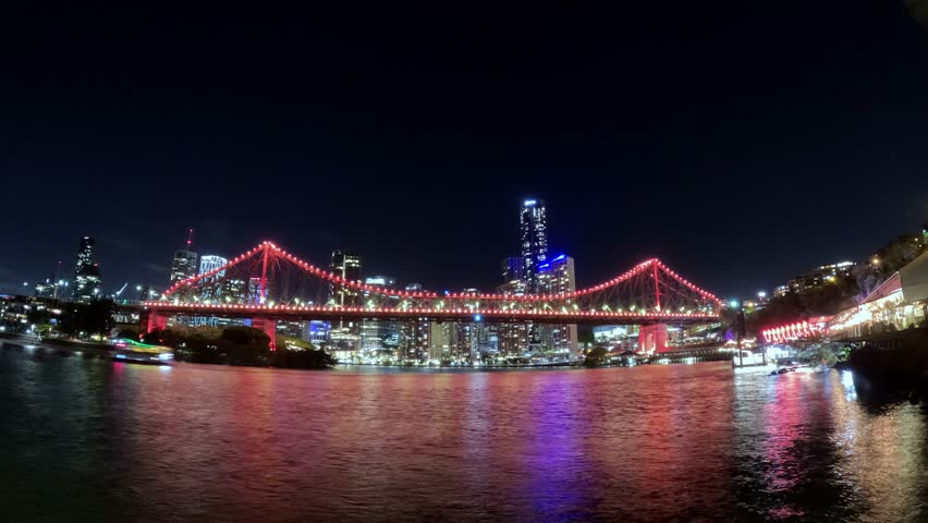 Story bridge illuminating brisbane skyline at night
