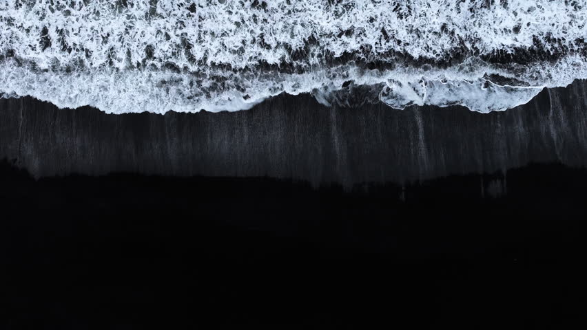 Black sand beach with crashing waves, Serene and tranquil landscape, Ocean coast with calm waves, Famous landmark of Iceland, Black sand of volcanic origin aerial view