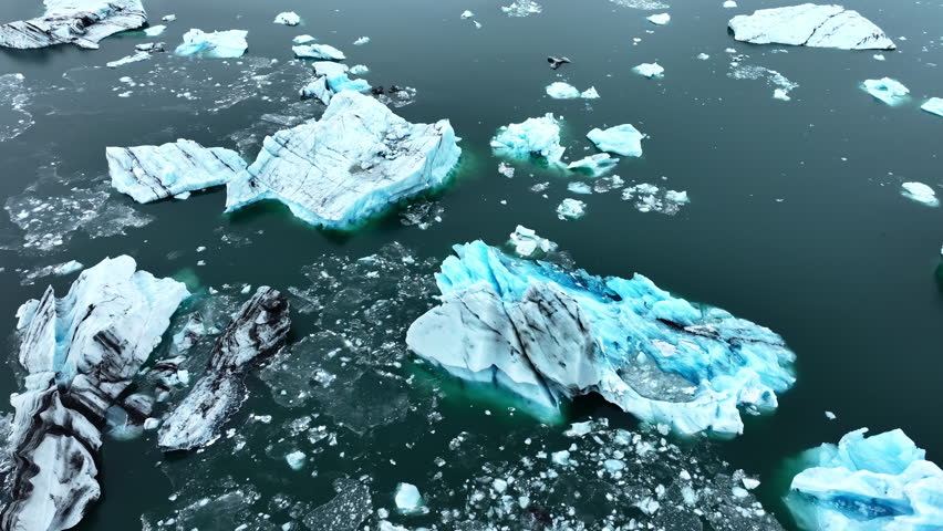 Iceberg in the ocean, Huge chunks of blue glacier Ice floating on the waves, Arctic Nature in Iceland