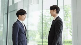 Asian businessmen shaking hands in a lobby - Powered by Shutterstock - Get 15% off with code: PIKWIZARD15